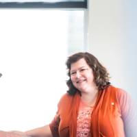 Deana Wiebel smiles as she's introduced to speak.